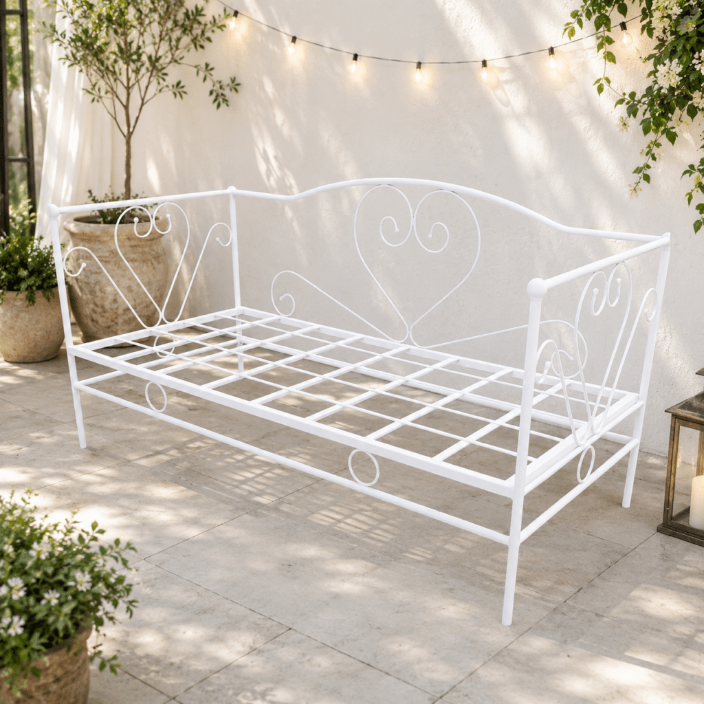 Wrought iron chaise lounge placed in an outdoor garden or patio space.